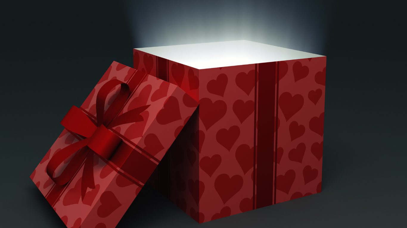 Red gift box with a heart pattern and a bright glow emanating from inside, indicating a surprise