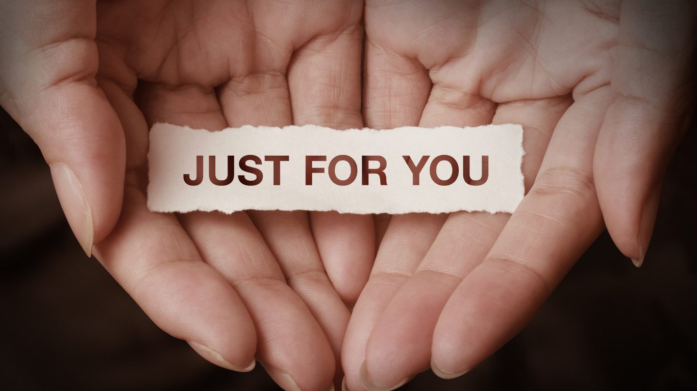 Two hands holding a piece of paper with the words 'JUST FOR YOU' written on it, suggesting a personalized gift for entrepreneurs